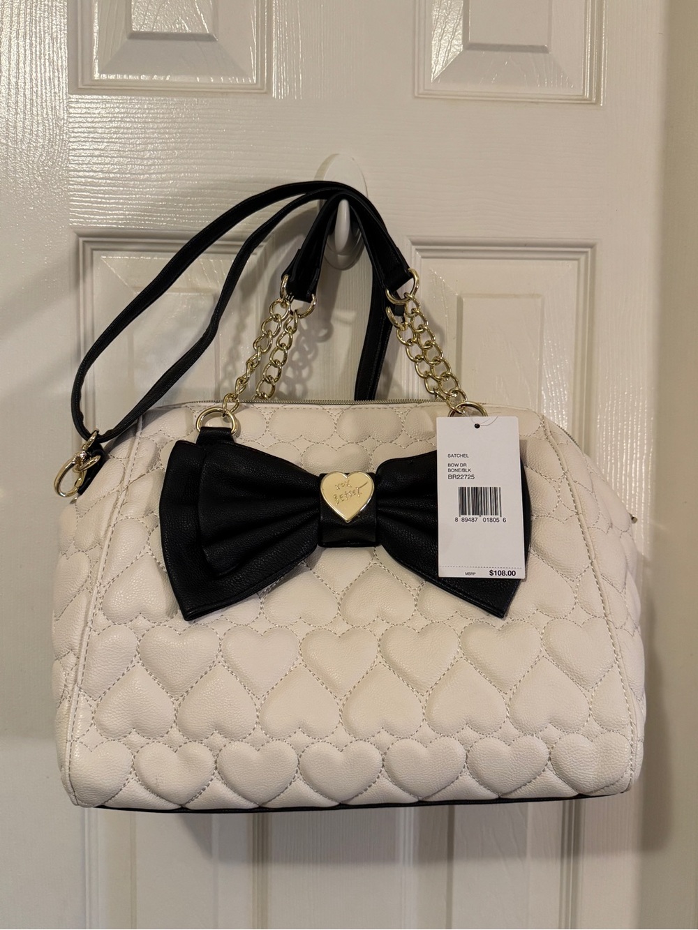 A Betsey Johnson White Quilted Heart Satchel with Black Bow